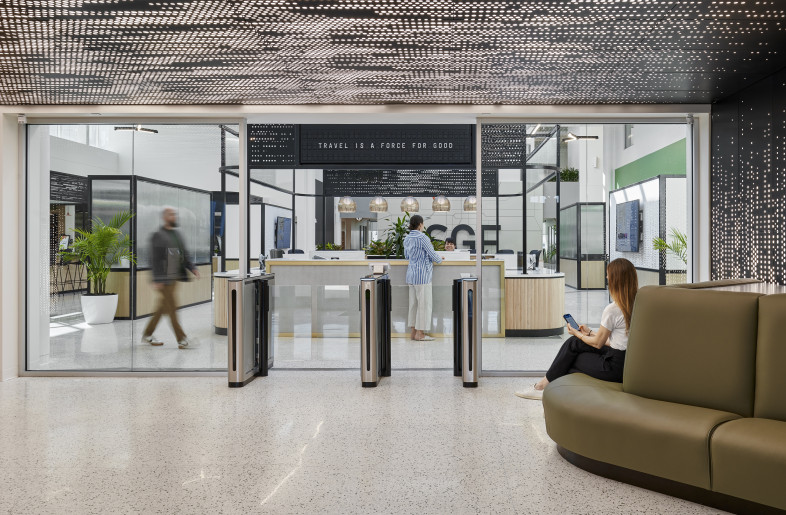 The entry is compressed with a lower ceiling and backlit perforated metal panels to give the appearance of dappled light through a tree canopy. - Ryan Gobuty