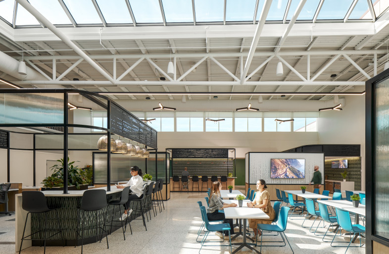 Once in the large double height gathering space – the Social Hub, the existing features of the airport are celebrated through intentional light fixtures, placement of millwork “kiosks”, and views to the sky. - Ryan Gobuty