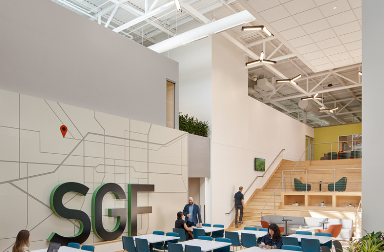 Further into the Social Hub, the existing connection stair was re-envisioned as a gathering area for large functions. The branding was intentionally designed to reflect the old airport code. - Ryan Gobuty