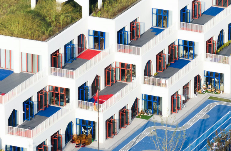 Mimicking a manmade hill when looked from a distance, the stacked building blocks of West Coast Kindergarten create a playful and inviting environment for learning. - Chill Shine