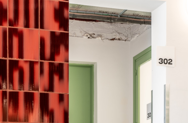 A contrasting color palette of burgundy, blue, and green, adds a contemporary touch to the design without clashing with the building's classic aesthetics - Miguel Fernández-Galiano