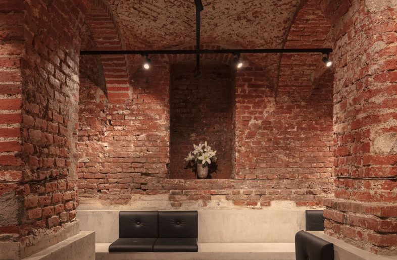 historic brick, black 3-phase rail, polished and sealed concrete, red marble, black leather, handmade ceramics, white lilies - Kim Fohmann