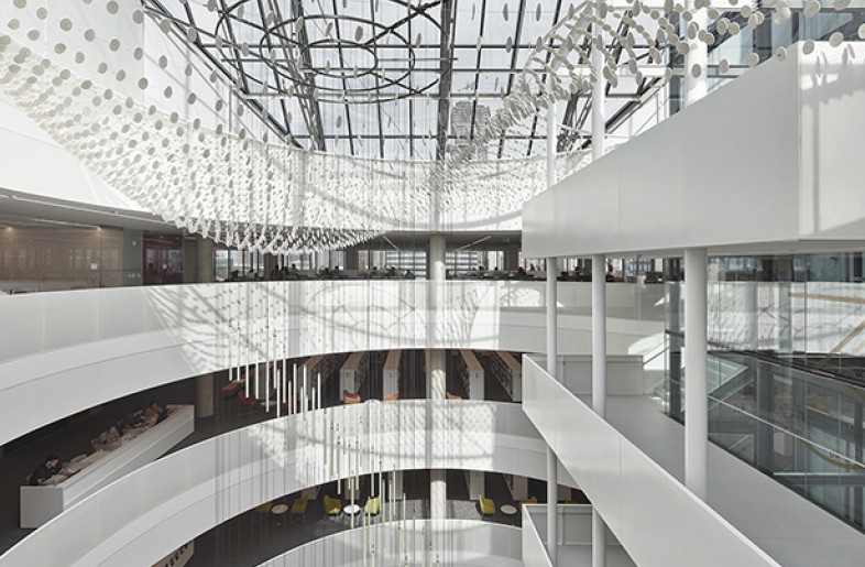 The refined atrium space works in harmony with the spiraling LED arrangement of Lightfall, an art installation by Nathan Whitford. - Tom Arban
