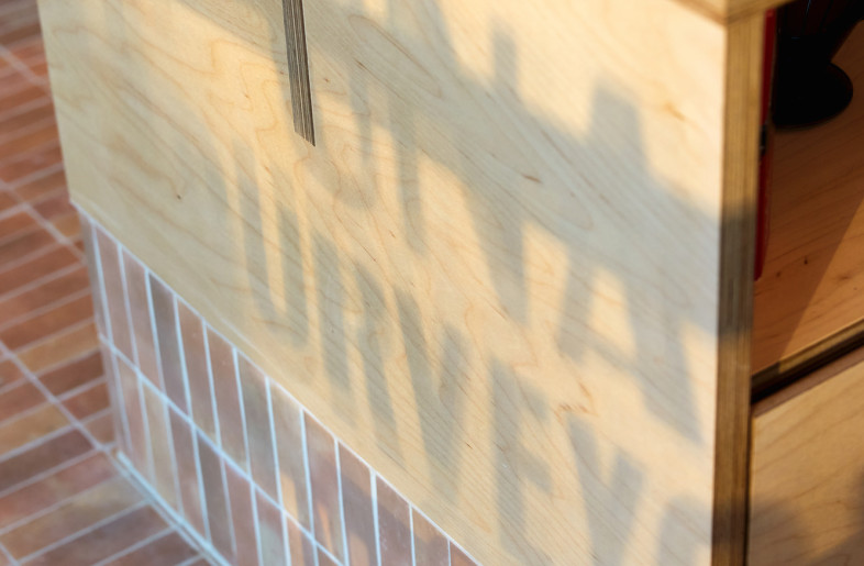 Modular plywood shelving with brick tiles - Steven Woodburn