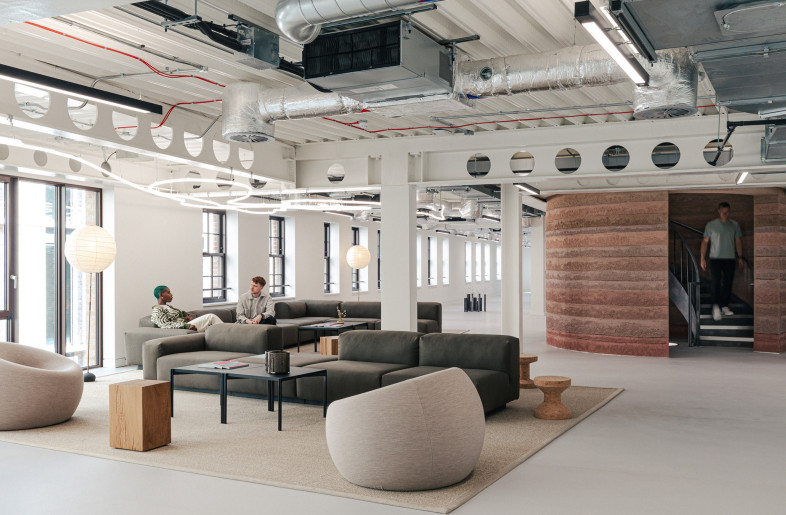 Lounge area featuring lighting that traces the London Marathon route, with a sculptural staircase expressing movement and endurance through form and materiality. - Chris Wharton