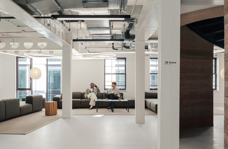 Lounge area featuring lighting that traces the London Marathon route, with a sculptural staircase expressing movement and endurance through form and materiality. - Chris Wharton