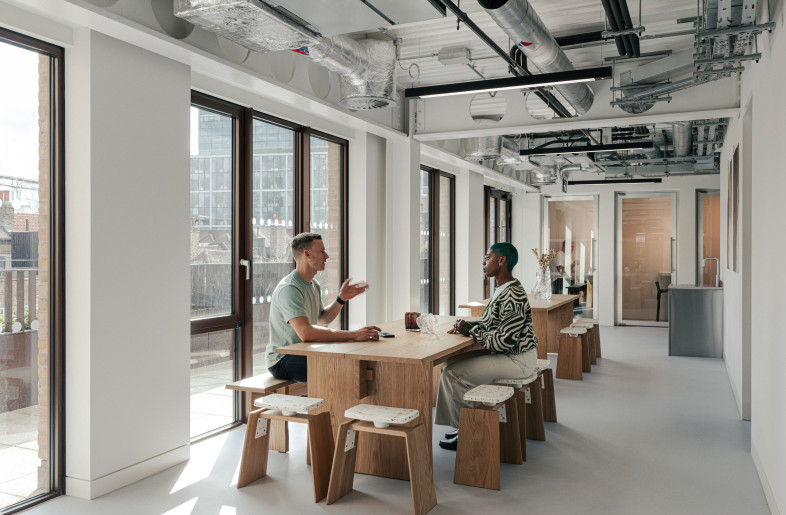 Collaboration zone positioned by the windows and water point, offering natural light and easy access to refreshments. - Chris Wharton