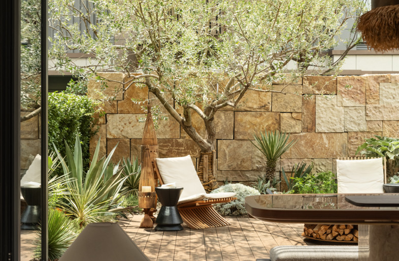 The ground - floor's main social area, connected to the courtyard, offers residents an open and airy reception space. - Courtyard