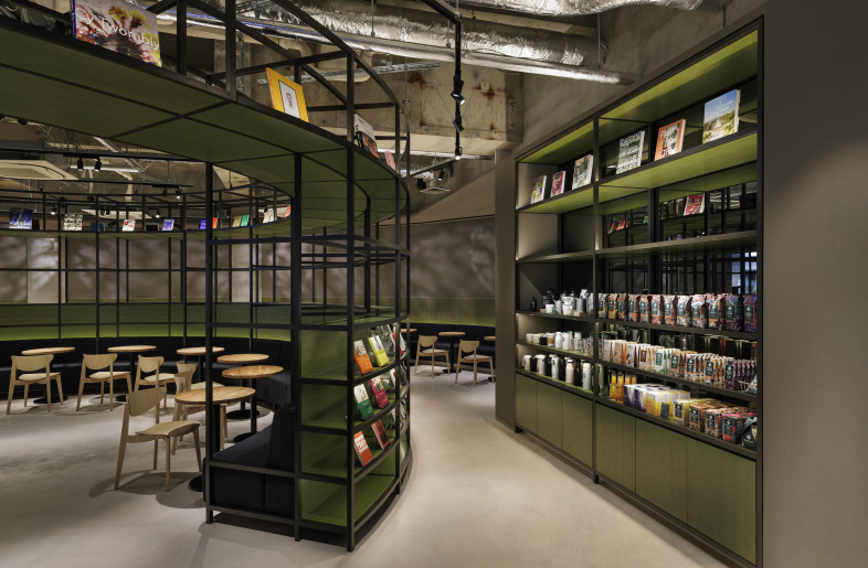 Around the retail area of the café. We introduced the recessed circulation paths outside the circular frame furniture to subtly define zones for different uses. - Nacása & Partners Inc.