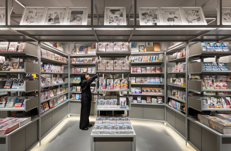 The sixth floor houses a bookstore dedicated to Japanese IP (Intellectual Property) content. The fixtures are unified in gray tones, creating a spatial composition that allows the content to take center stage. - Nacása & Partners Inc.