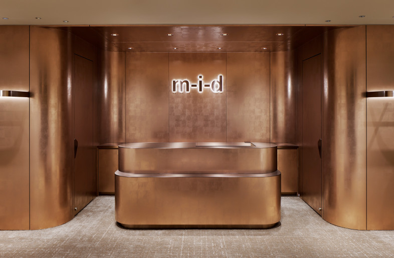 Reinforcing the striking impression of the space, the copper on the front gate is layered into the back wall and furniture. - SATOSHI SHIGETA