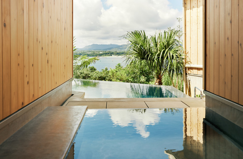 The open-air bath is in the foreground and the pool is at the back. The view goes all the way to the sea. - Ju Yeon Lee