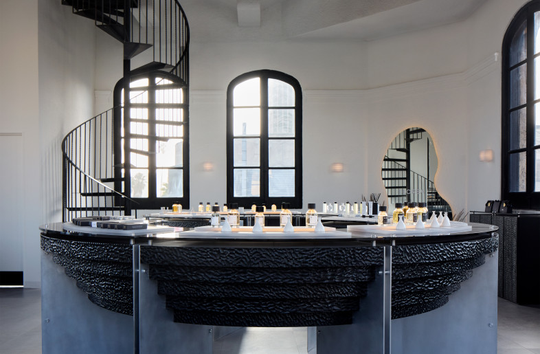 The altar-like central display at Elorea is framed by soft morning light and a dramatic spiral stair, blending spiritual quietude with sculptural intensity. - Ye Rin Mok