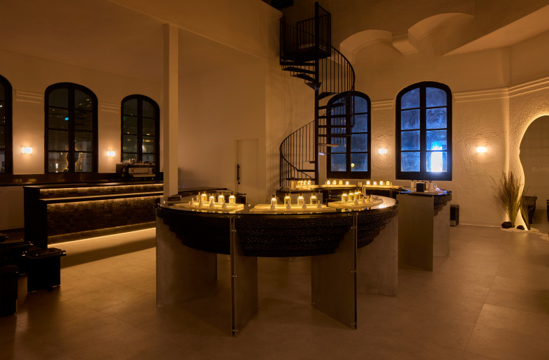 Elorea at night: illuminated perfume displays shimmer beneath the historic dome, evoking the quiet glow of votive candles. - Ye Rin Mok