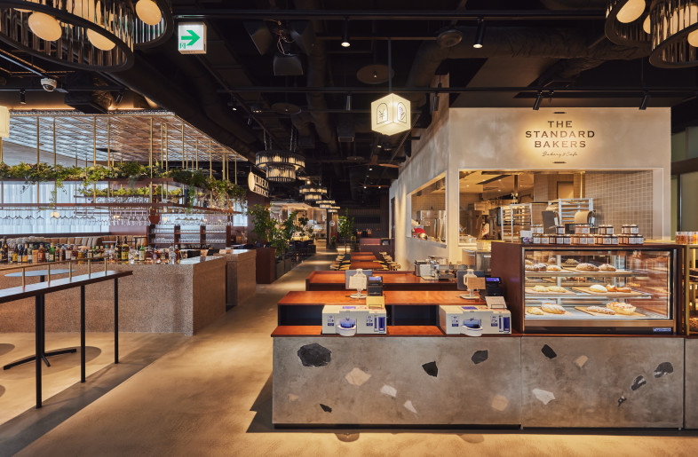 The central space is anchored by the bakery showcase, its terrazzo finish thoughtfully designed to evoke the pebbles of Hiroshima's flowing rivers. - Photographer Shinsui Ohara
