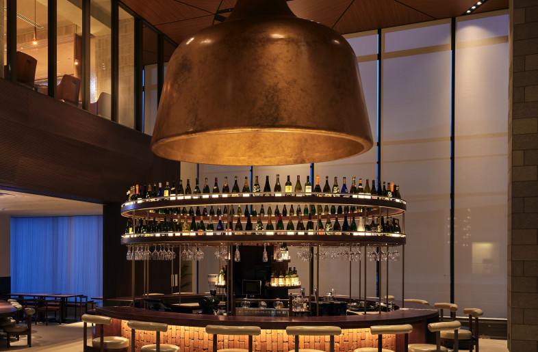 Restaurant Entrance and Bar. The prominent hanging pod draws guests into the vibrant atmosphere of the restaurant and bar area. - Photographer Shinsui Ohara