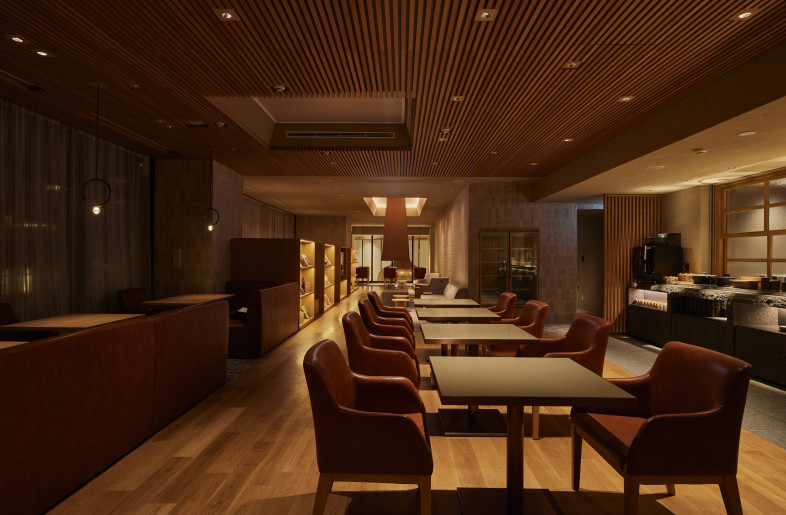The Second Floor Lounge Zone. Soft lighting and comfortable seating define the second-floor lounge, offering a refined space for guests to unwind and enjoy the ambiance. - Photographer Shinsui Ohara