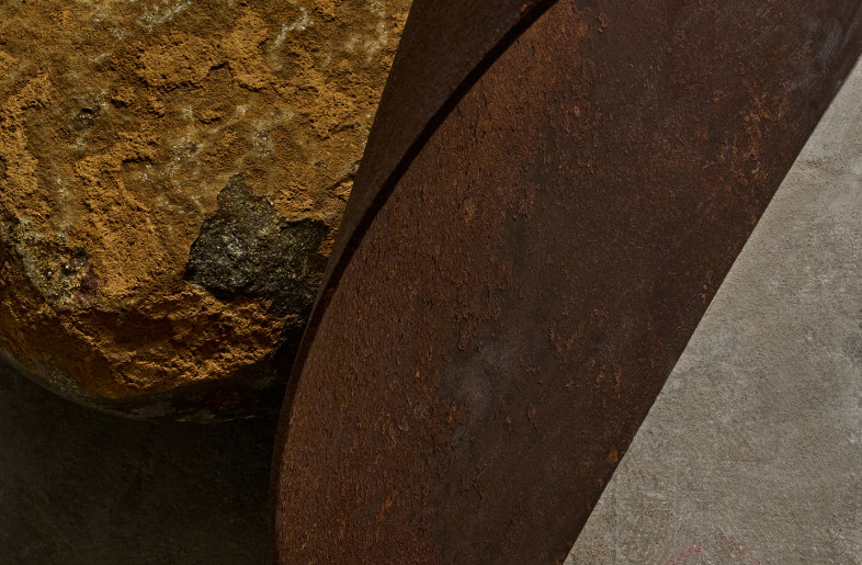 The steel plate and the stone are fixed so that they are leaning against each other. Neither is the main component, but they support each other. This is an expression of the concept of the reunion of the memories of the each materials. - Masayuki Hayashi
