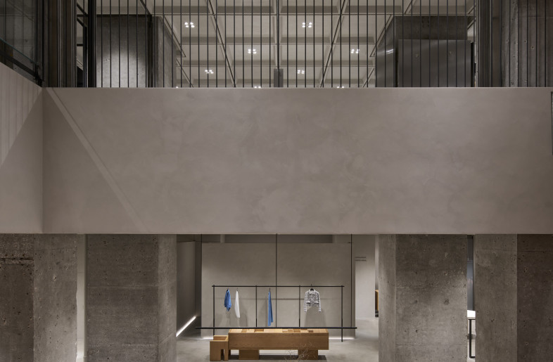 Exposed structural columns, polished concrete floors, and a concrete cassette ceiling establish a bold yet serene architectural language - Seth Powers