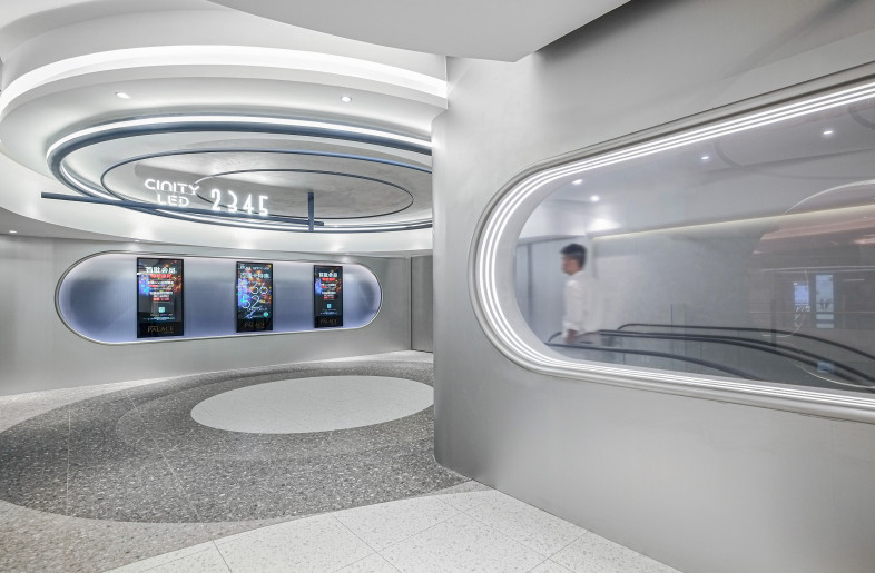 Passing through the ticket checkpoint, moviegoers enter a space where reality blurs with the virtual worlds of film. - Design Action