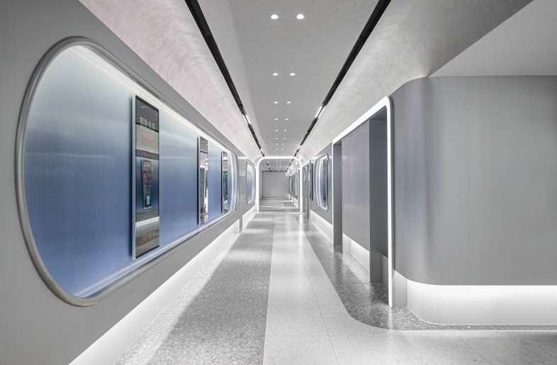 Dawnlight Passage: The light trough runs through the entire ceiling of the corridor, with black recesses integrating lighting and signage that extend to the end of the passage, creating a cleaner overall visual effect. - Design Action