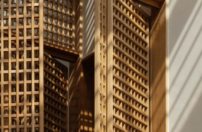 Solid teak partitions rotate and slide, allowing the owners to adjust privacy, transparency, and lighting throughout the day. - Natelee Cocks