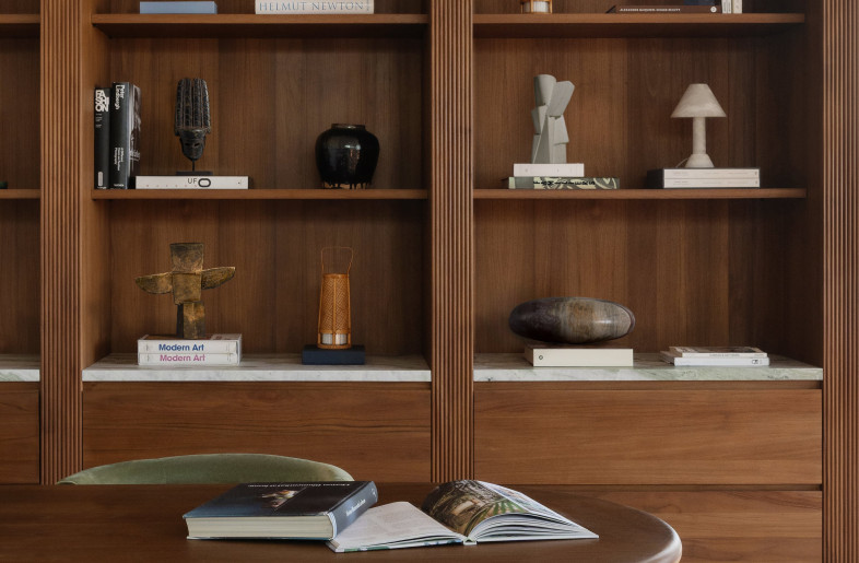 A private office with bespoke shelving (solid teak, marble), bespoke table (solid teak, concrete), and Charlotte Perriand’s Indochine chair. - Natelee Cocks