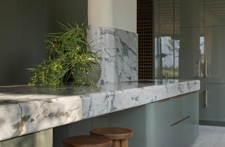 Calacatta Verde marble worktops and clay-green lacquer cabinets. Bespoke teak and brass stools. - Natelee Cocks