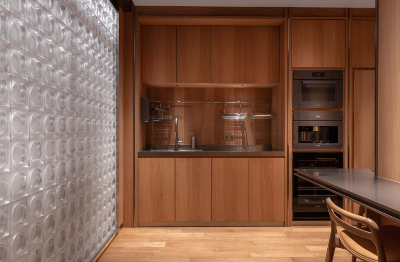 Glasswork integrates mid-century geometry, illuminating shared spaces while preserving privacy. - Dennis Lo