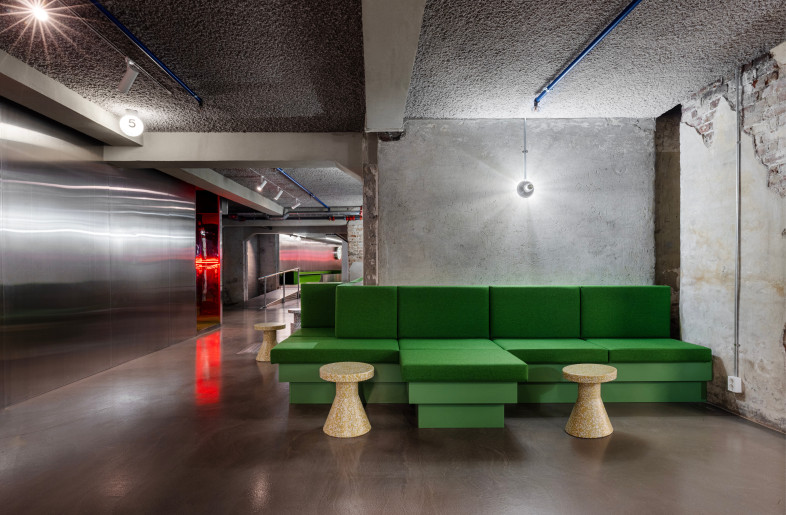 In the basement, custom-designed furniture reveals the existing concrete structure and wraps around it. - Ben Speck