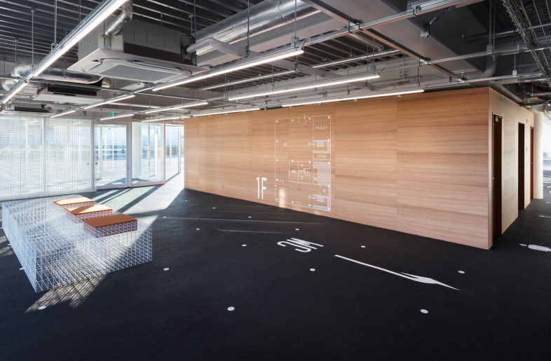Entrance space. General road markings are pulled into the interior. - Takumi Ota