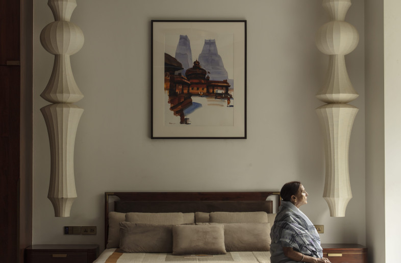 The bold and dramatic bedside lights perfectly complement the understated elegance of the grandmother's room - NIVEDITAA GUPTA