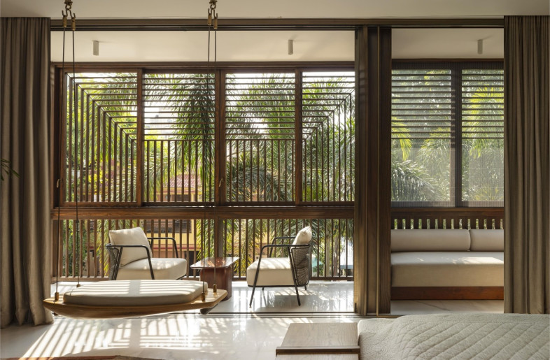 Timber lattices veil the facade, ensuring privacy, filtering sunlight and enhancing air flow - NIVEDITAA GUPTA
