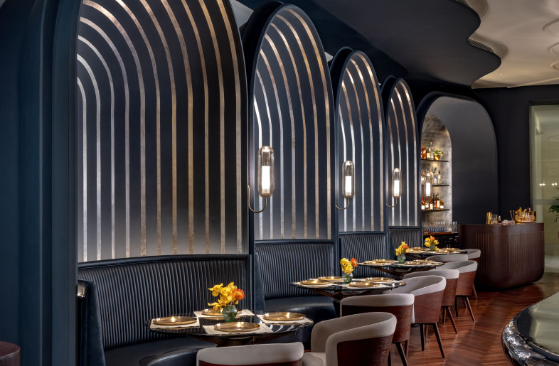 Solid walnut parquet flooring, monolithic chairs, and a rich, moody palette enhanced with dynamic lighting ground the space in timeless charm, where guests can choose between dining experiences tailored to different moods and occasions. - Jeetin Sharma