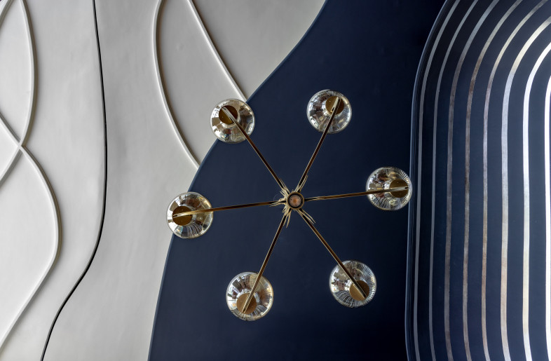 The design of the ceiling enhances a layered design narrative with sinuous grooves and a contrasting colour palette. Its varying levels introduce depth while seamlessly integrating services to maintain functionality without disrupting the visual rhythm. - Jeetin Sharma