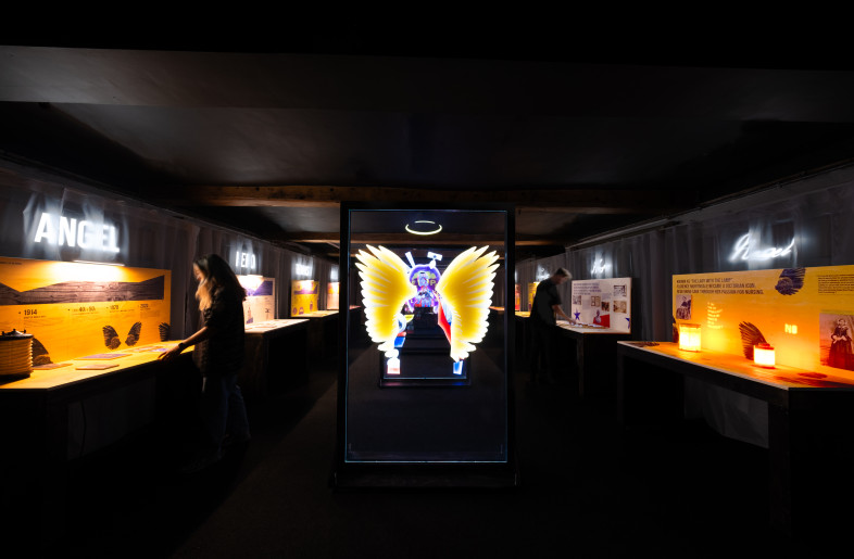 Frontal view of the space revealing the acrylic screens guiding the eye towards Nightingale’s digital portrait at the center, flanked by modular exhibits—public perception on the left, and her true character on the right. - Angus MacKinnon