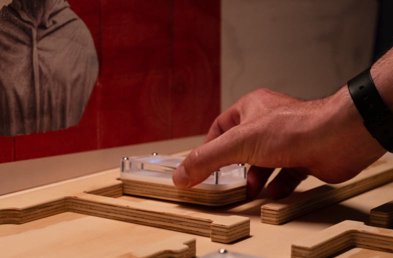 A visitor engages with the ‘Design a Hospital’ interactive, strategically placing beds to reflect Nightingale’s principles of hospital layout and patient care. - Angus MacKinnon