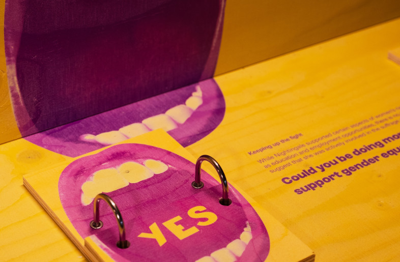 Detail of the feminist moral questions interactive, where visitors flip wooden cards to share their responses. - Angus MacKinnon