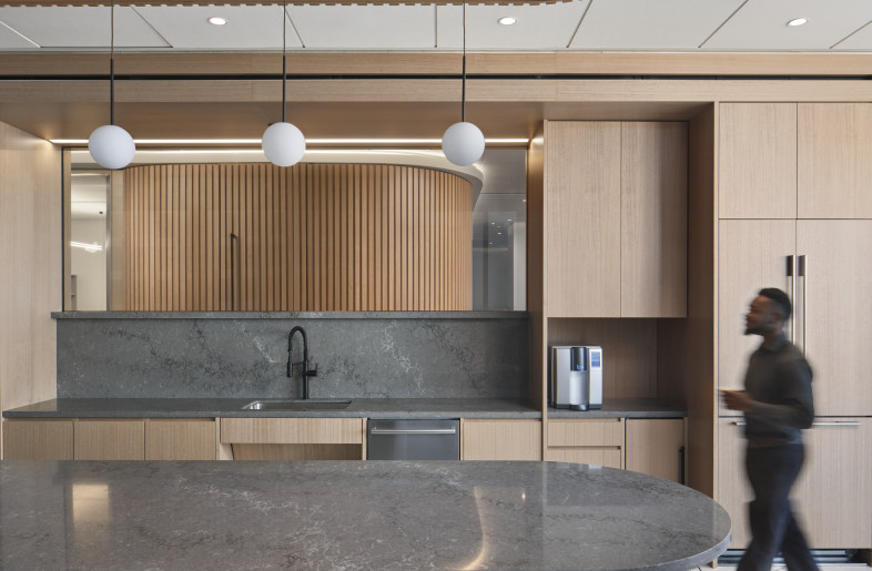 Close-up of curved forms, fluted details, and rich hues in the breakroom. - Andrea Calo