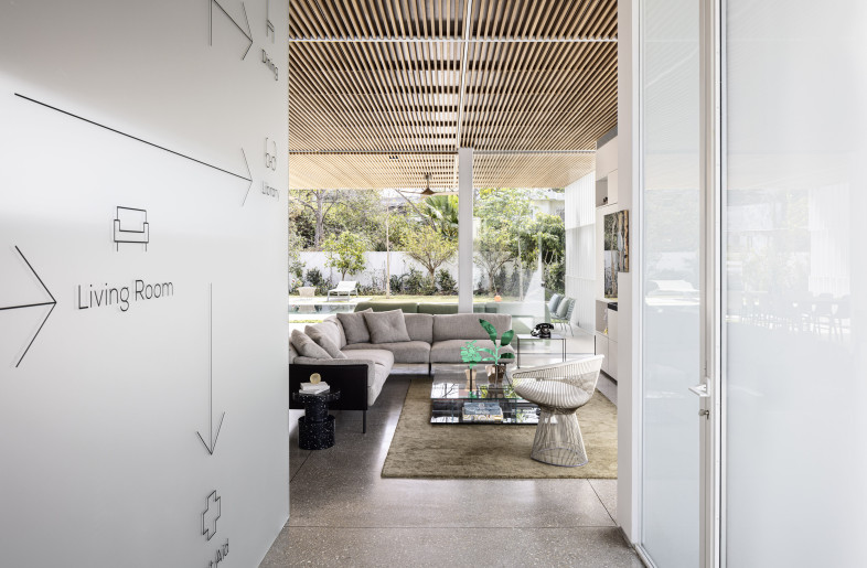 The ceiling slats extend outwards to the covered exterior area, creating a continuous, linear language that binds the indoor and outdoor spaces into a single integrated unit. - Amit Geron