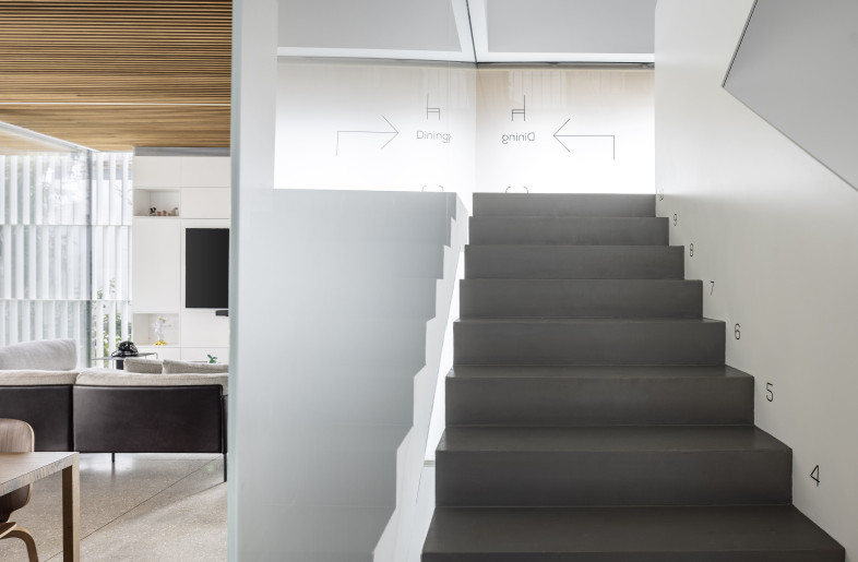 Key domestic functions are compactly organized and discreetly hidden behind a veil of frosted glass. - Amit Geron
