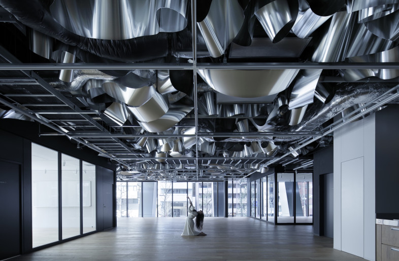 Further into the office, there are spaces for hosting events and performances, promoting inspiration and socializing. - Daisuke Shima