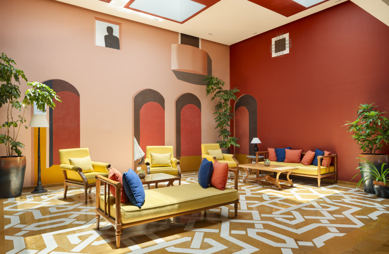 A view of the Lobby Lounge, which was earlier a semi covered fountain area. A portugese street pattern in lay flooring and custom skylights have been introduced. A captivating mural is the focal element while the new furniture is upholstered in Cidade De Goa's colors - Andre Fanthome (Studio Noughts and Crosses)