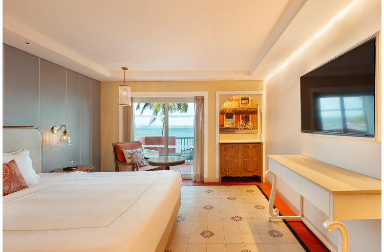 View of the standard king room which keeps focus on the spectacular sea views. Orange is used as an accent color and the room is filled with subtle Indo-Portugese details. - Andre Fanthome (Studio Noughts and Crosses)
