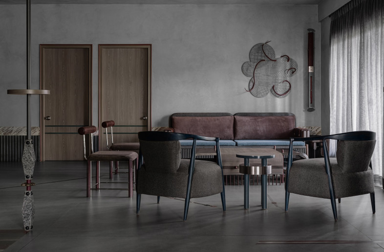 The living area eschews the conventional TV wall, creating a low-slung environment for conversation. - Ishita Sitwala