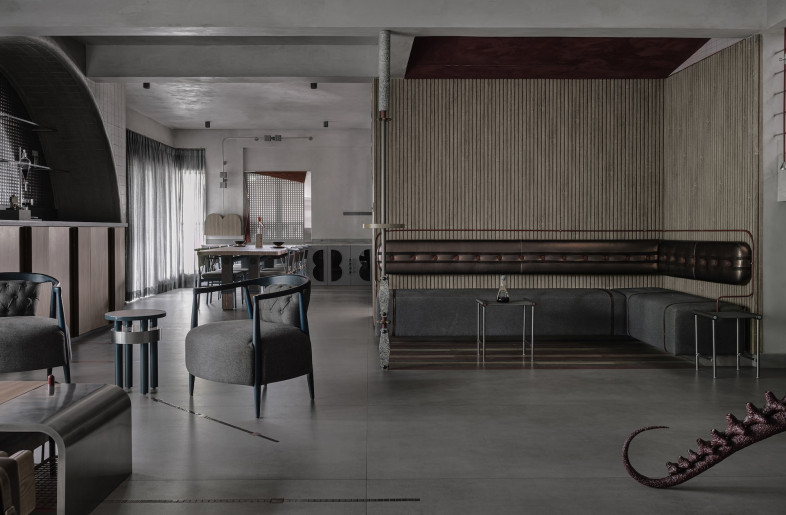 A built-in banquette with heavy-gauge linen upholstery carves an intimate dining space. - Ishita Sitwala