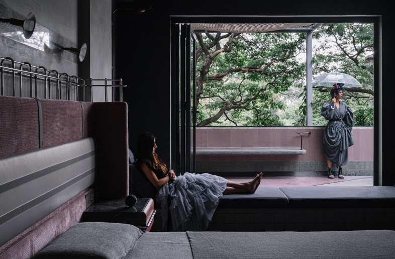 A glazed accordion door blurs the boundary between indoor and outdoor living. - Ishita Sitwala