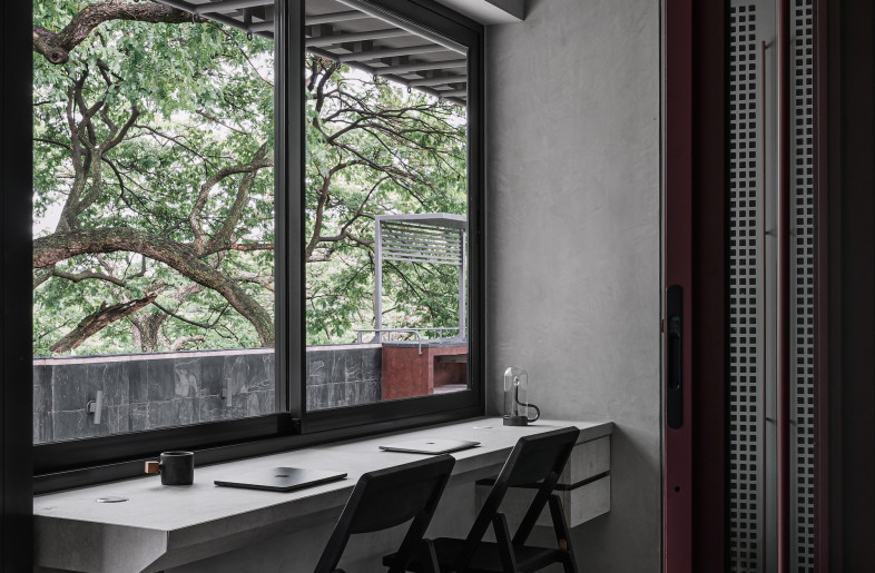 A pinch-point between bedroom and living zones becomes a work nook with a cantilevered steel desk. - Ishita Sitwala
