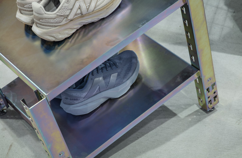 For FW24, the repurposed steel racks were updated with a rainbow interference finish through chromate treatment, inspired by the blurred photo prints featured in the collection. A non-toxic trivalent chromium was chosen to achieve both aesthetics and sustainability, aligning with global environmental standards. Additionally, a matching shoe rack was created using scraps from the garment rack posts. - Kenta Hasegawa
