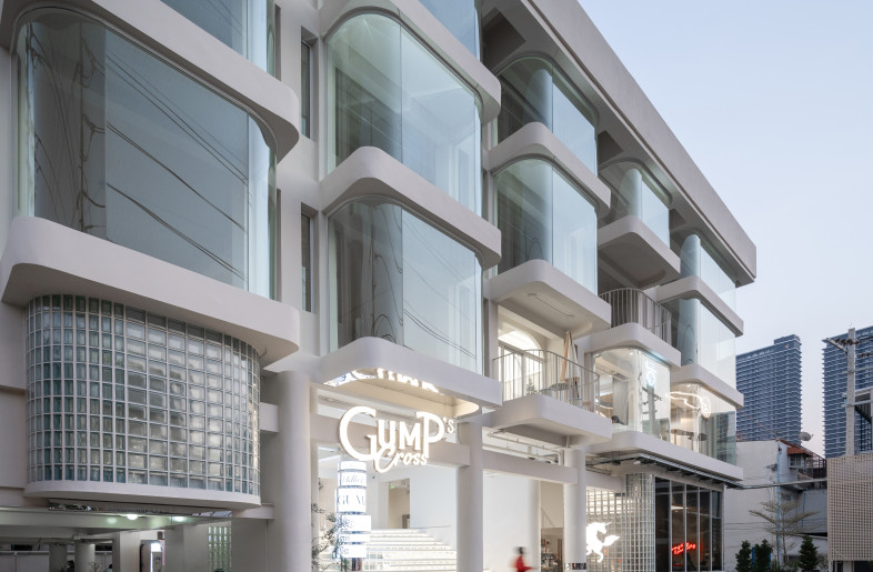 The main stair connects upper floors and uses translucent materials to let light reach the retail and event spaces at the back. - Rungkit Charoenwat